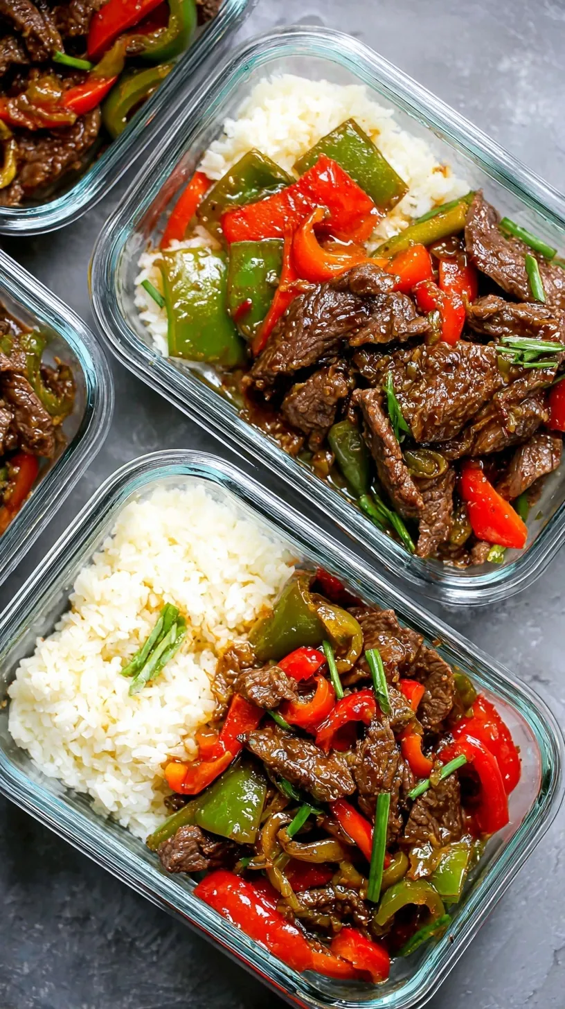 A colorful pepper steak stir fry with red and green bell peppers and tender beef strips in a savory sauce.