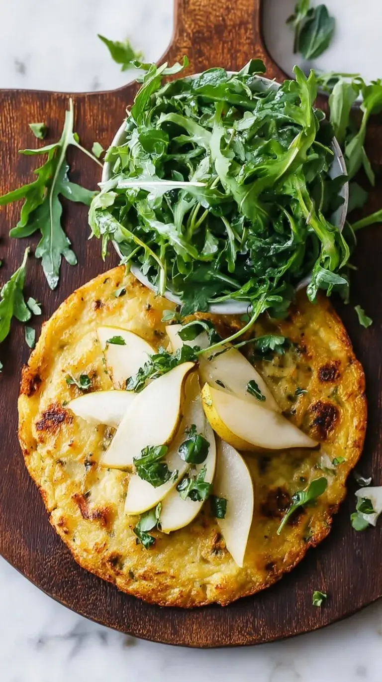 Golden crispy socca flatbread topped with sliced pears, fresh arugula, and toasted walnuts on a wooden board.